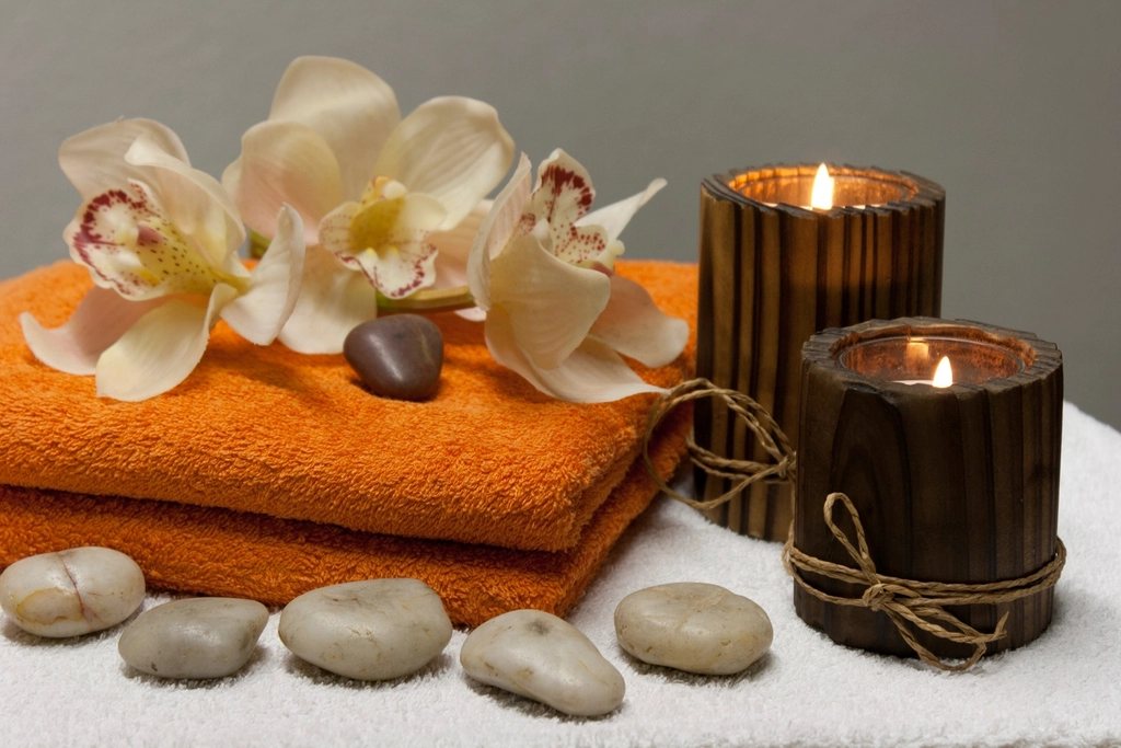 Candles, orchids and folded towels